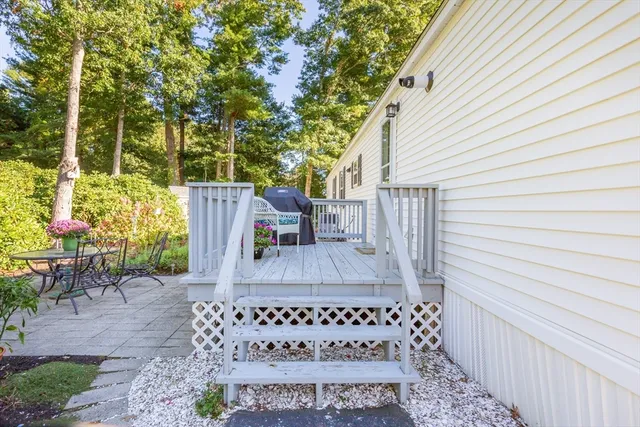 a view of a house with a tree and a yard