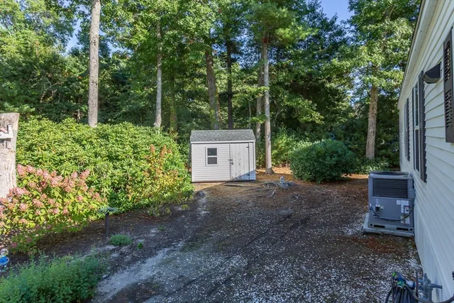 a backyard of a house with barbeque oven fire pit table and chairs
