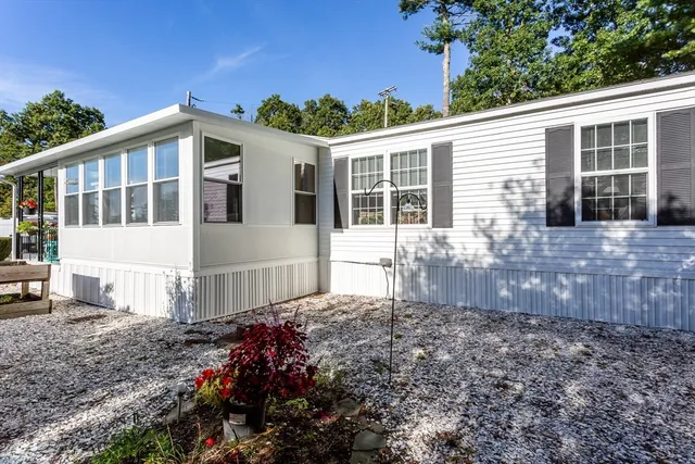 a view of a house with backyard sitting area and garden