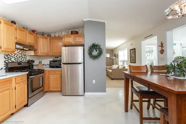 a kitchen with refrigerator and cabinets
