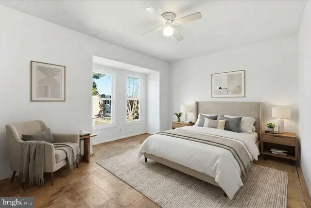 a bedroom with a bed and chair