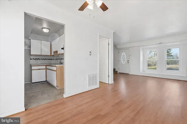 a view of kitchen with stove refrigerator and cabinets