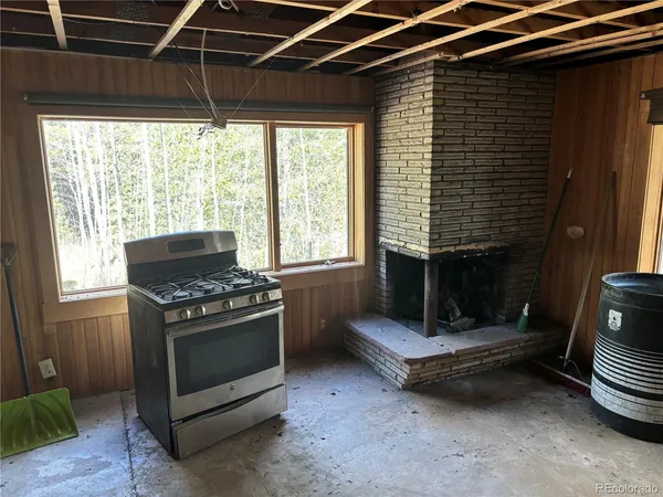 a stove top oven sitting inside of a kitchen