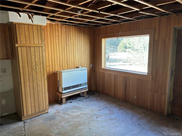 a view of a room with a door and a window