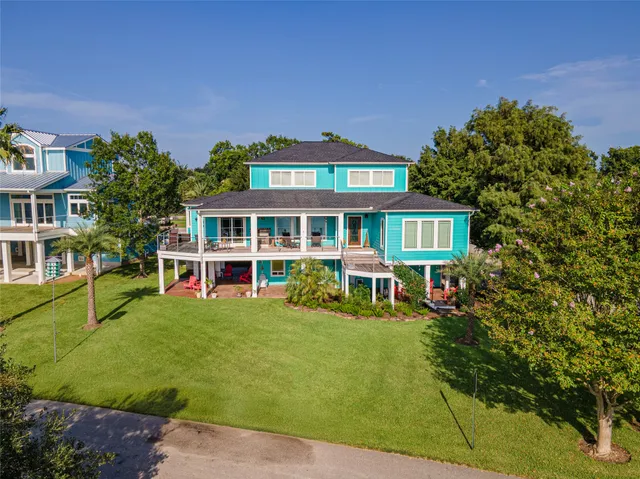 a view of a house with swimming pool and sitting area