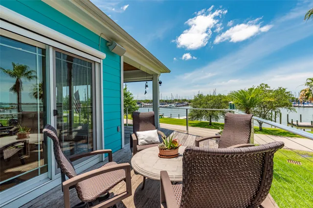 a view of a patio with a table chairs and a backyard