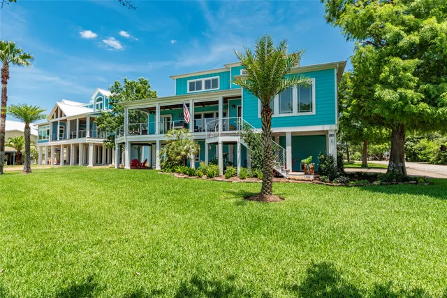a view of house with yard and sitting area