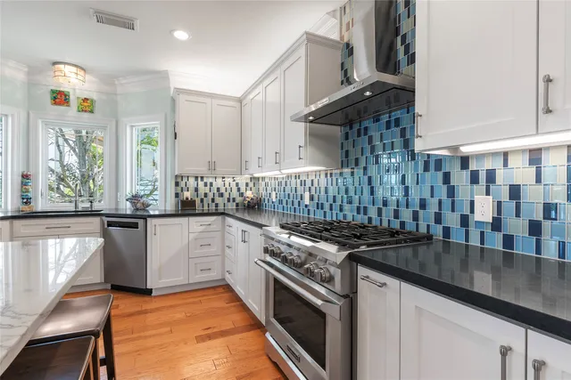 a kitchen with granite countertop a stove a sink and a granite counter tops