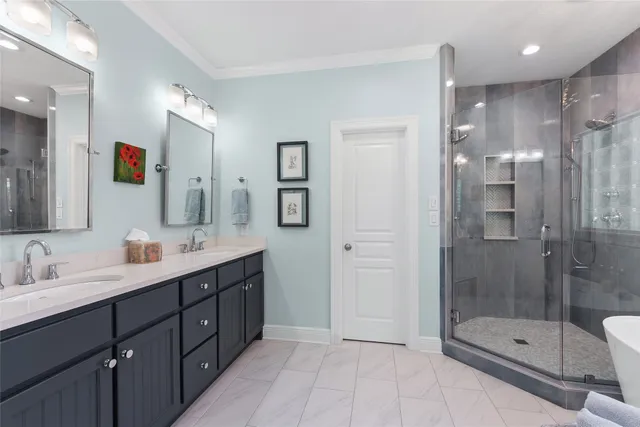 a bathroom with a shower sink double and mirror