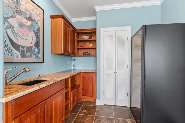 a utility room with a sink a vanity and a window