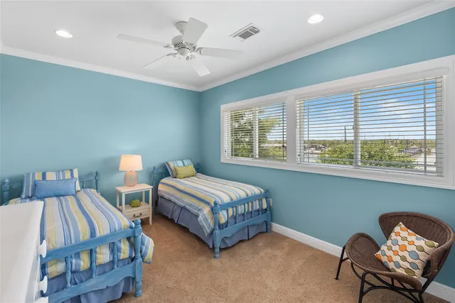 a bedroom with two beds and a chair