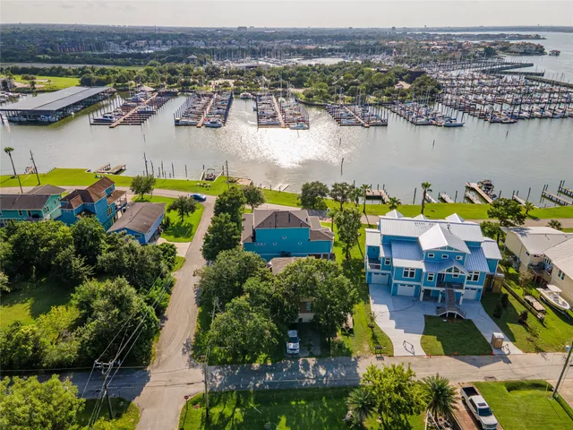 an aerial view of residential houses with outdoor space and swimming pool