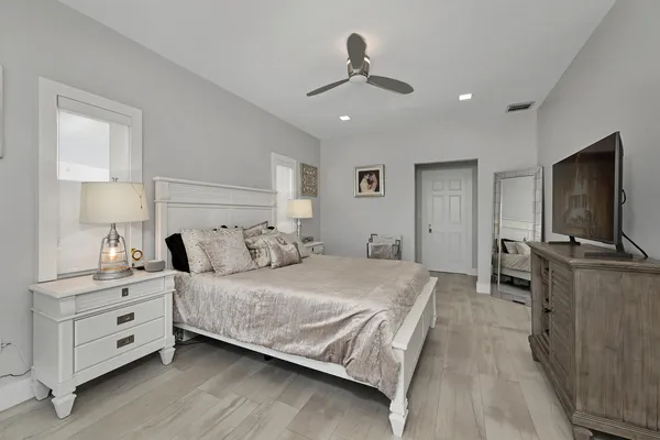 a view of a hallway with wooden floor and closet