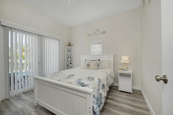 a bedroom with a balcony a bed and a walk in closet