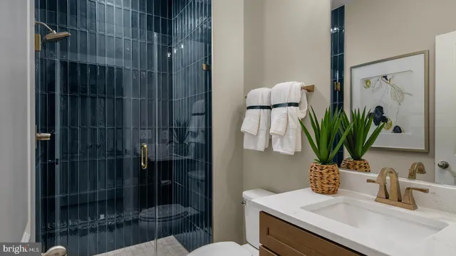 a bathroom with a shower a sink and mirror