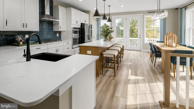 a kitchen with granite countertop a sink a counter top space appliances and cabinets