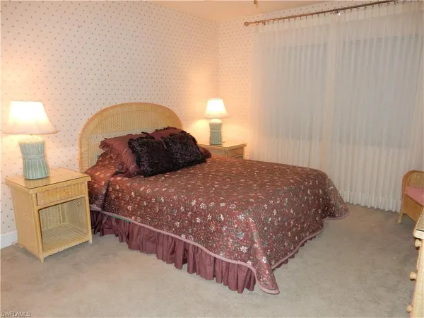 a bedroom with a bed and a lamp on roof