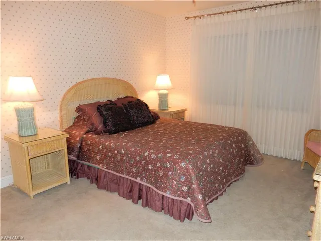 a bedroom with a bed and a lamp on roof