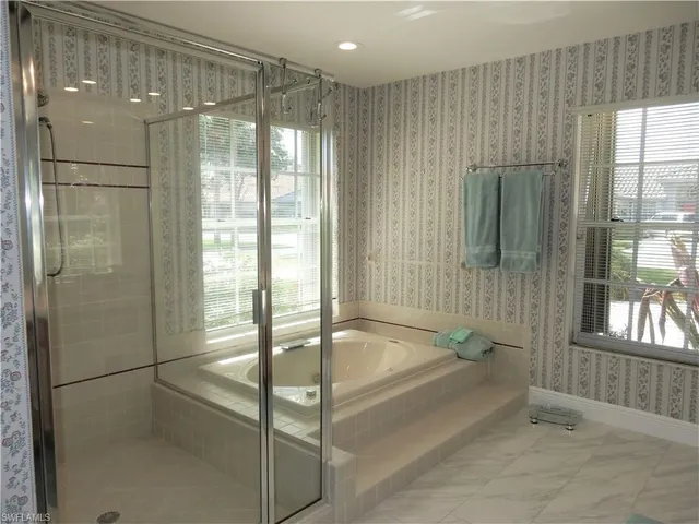 a bathroom with a tub and shower
