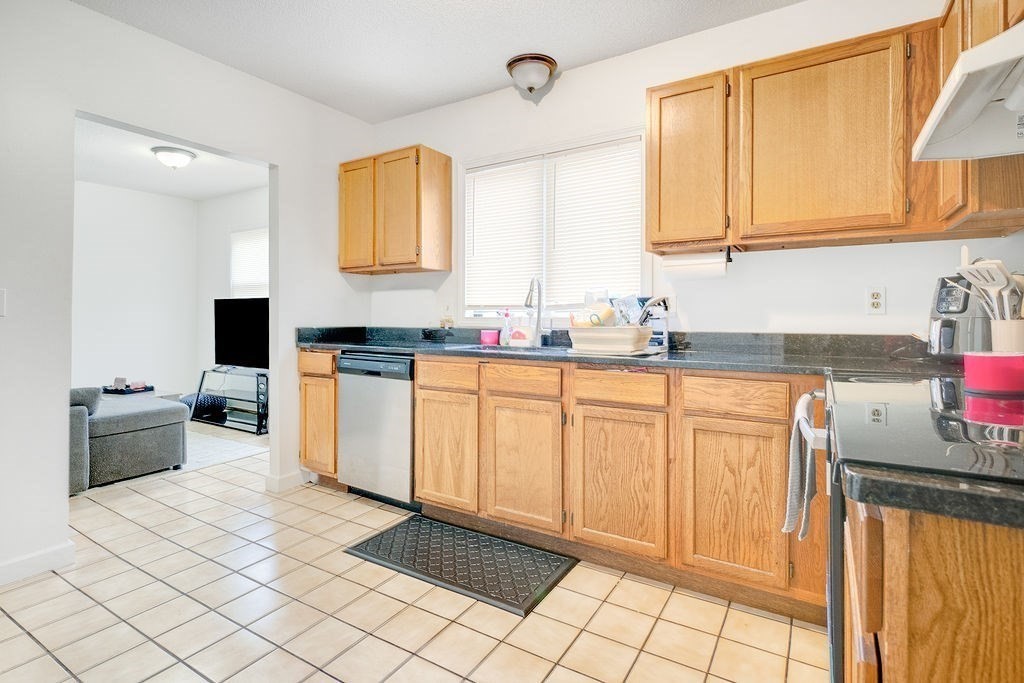 890-892 St James Avenue Springfield, MA 01104 - Photo 14 of 30 a kitchen with stainless steel appliances granite countertop a sink and cabinets