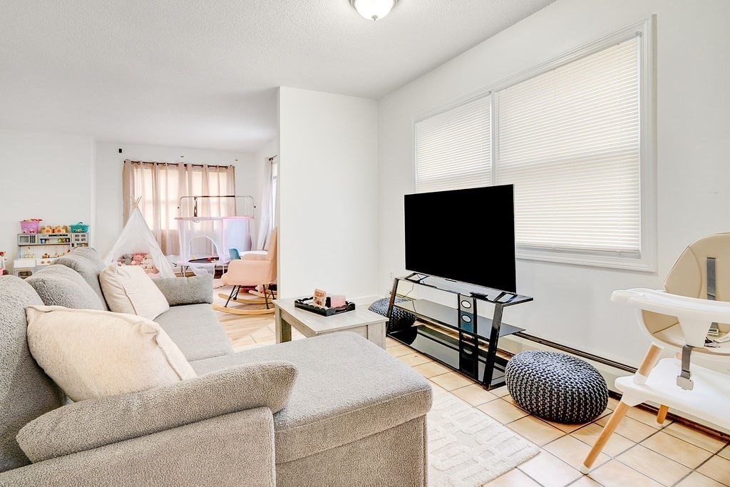 890-892 St James Avenue Springfield, MA 01104 - Photo 16 of 30 a living room with furniture and a flat screen tv