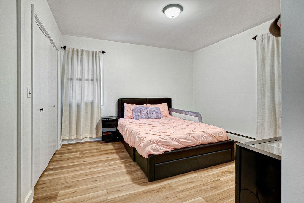 890-892 St James Avenue Springfield, MA 01104 - Photo 24 of 30 a bedroom with a bed and wooden floor