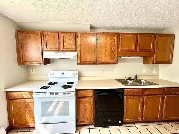 a kitchen with stainless steel appliances a stove sink and cabinets