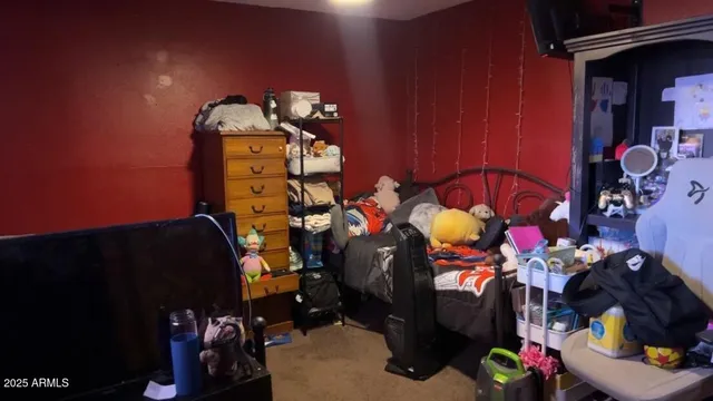 a bedroom with a bed and a desk