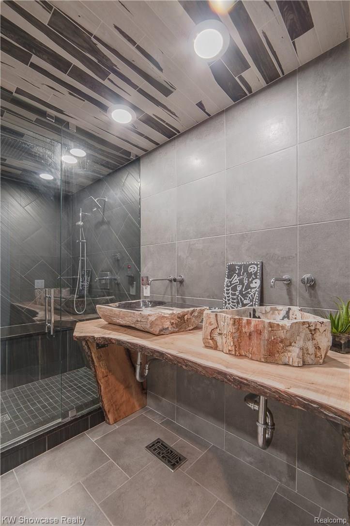 1110 Seneca Road Lake Orion, MI 48362 - Photo 37 of 50 Spectacular Stone Vessel Sinks in this Lower-Level Bathroom