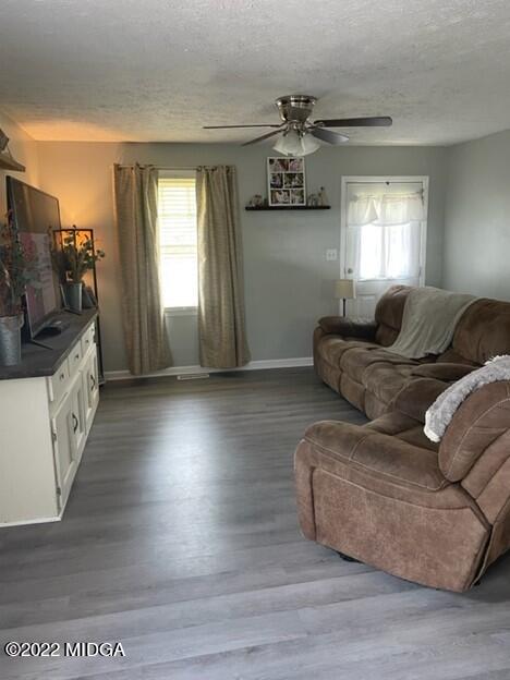 816 Lee King Road Forsyth, GA 31029 - Photo 3 of 15 a living room with furniture and a flat screen tv