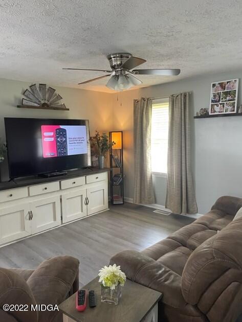 816 Lee King Road Forsyth, GA 31029 - Photo 4 of 15 a living room with furniture and a flat screen tv