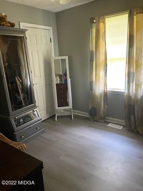 816 Lee King Road Forsyth, GA 31029 - Photo 5 of 15 a view of an empty room with wooden floor and a window