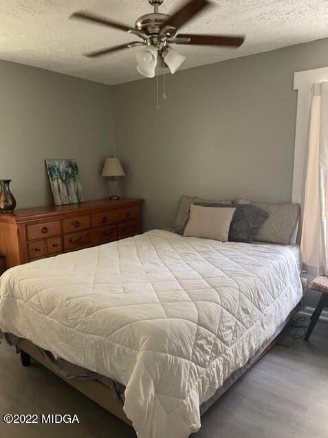 816 Lee King Road Forsyth, GA 31029 - Photo 7 of 15 a bedroom with a bed and a chandelier