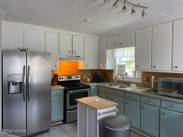 816 Lee King Road Forsyth, GA 31029 - Photo 9 of 15 a kitchen with a sink stove and refrigerator