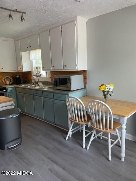 816 Lee King Road Forsyth, GA 31029 - Photo 10 of 15 a kitchen with a chair and cabinets