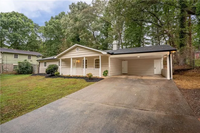 a front view of a house with a garden