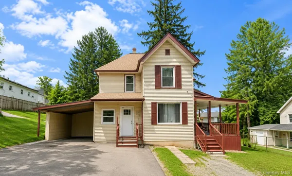 a front view of a house with a yard