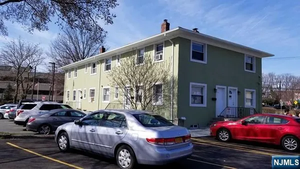a front view of a house with parking space