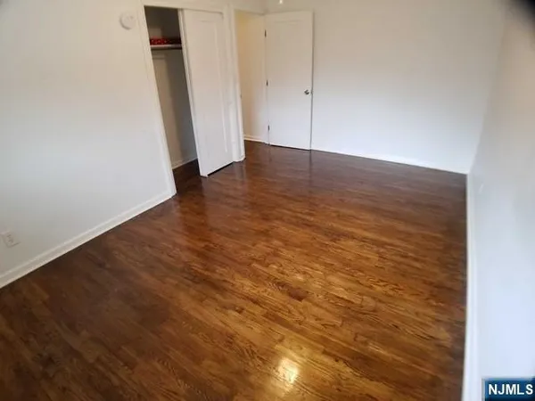 an empty room with wooden floor
