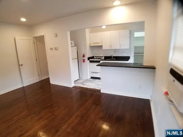 a large kitchen with a wooden floor and a sink