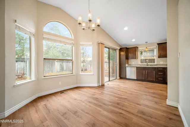 a view of a kitchen with microwave and windows