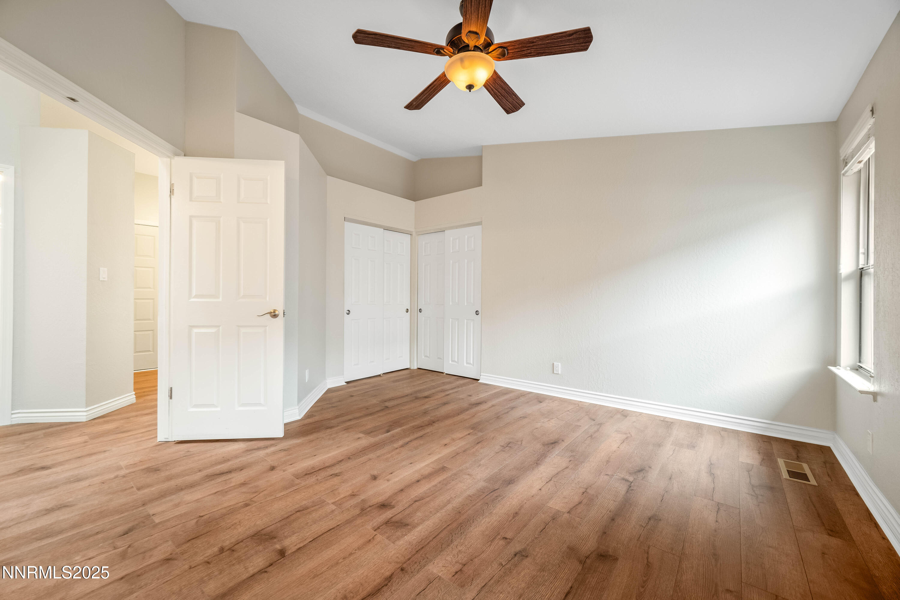1146 Ambassador Drive Reno, NV 89523 - Photo 11 of 23 wooden floor in an empty room with a window