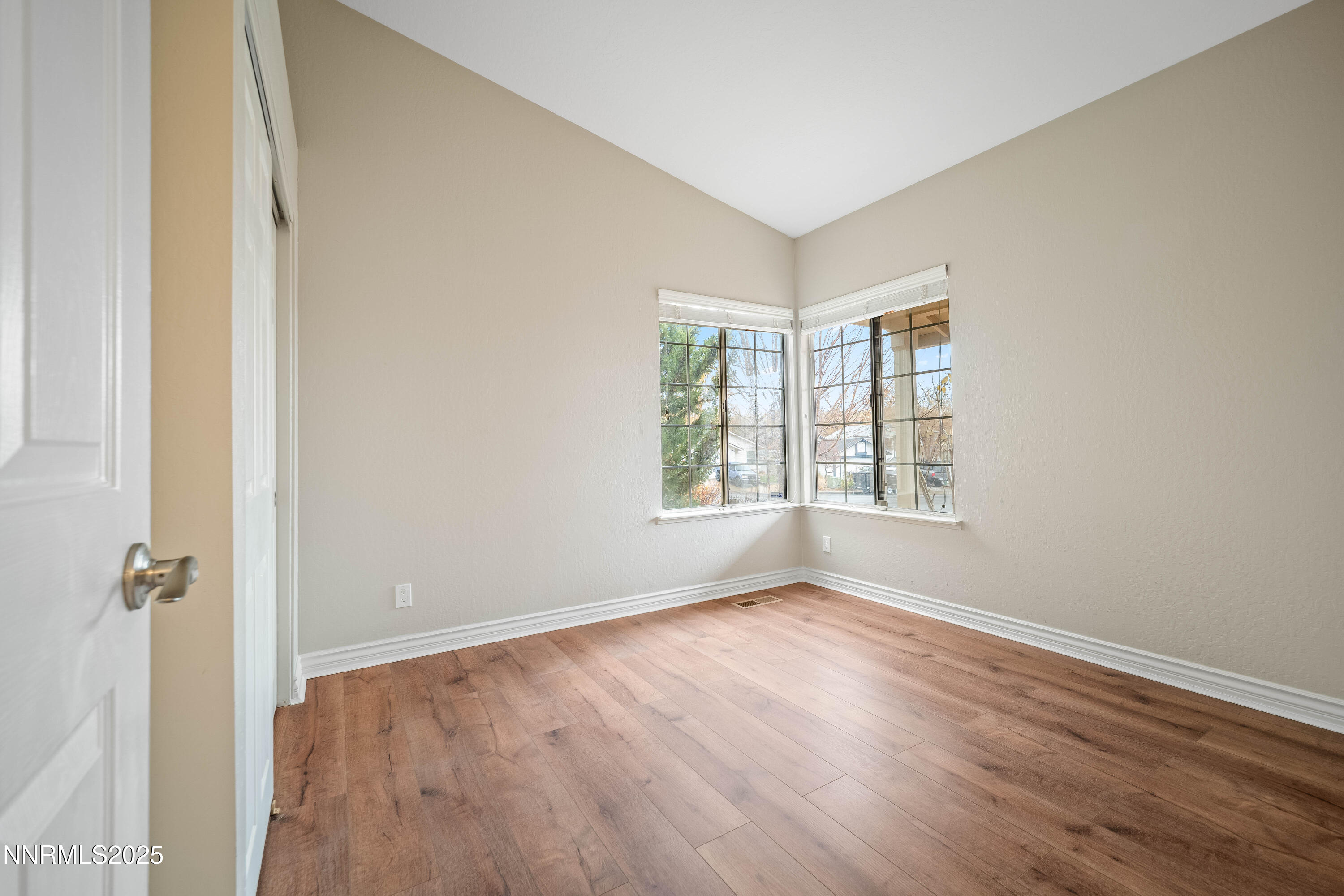 1146 Ambassador Drive Reno, NV 89523 - Photo 13 of 23 an empty room with wooden floor and windows