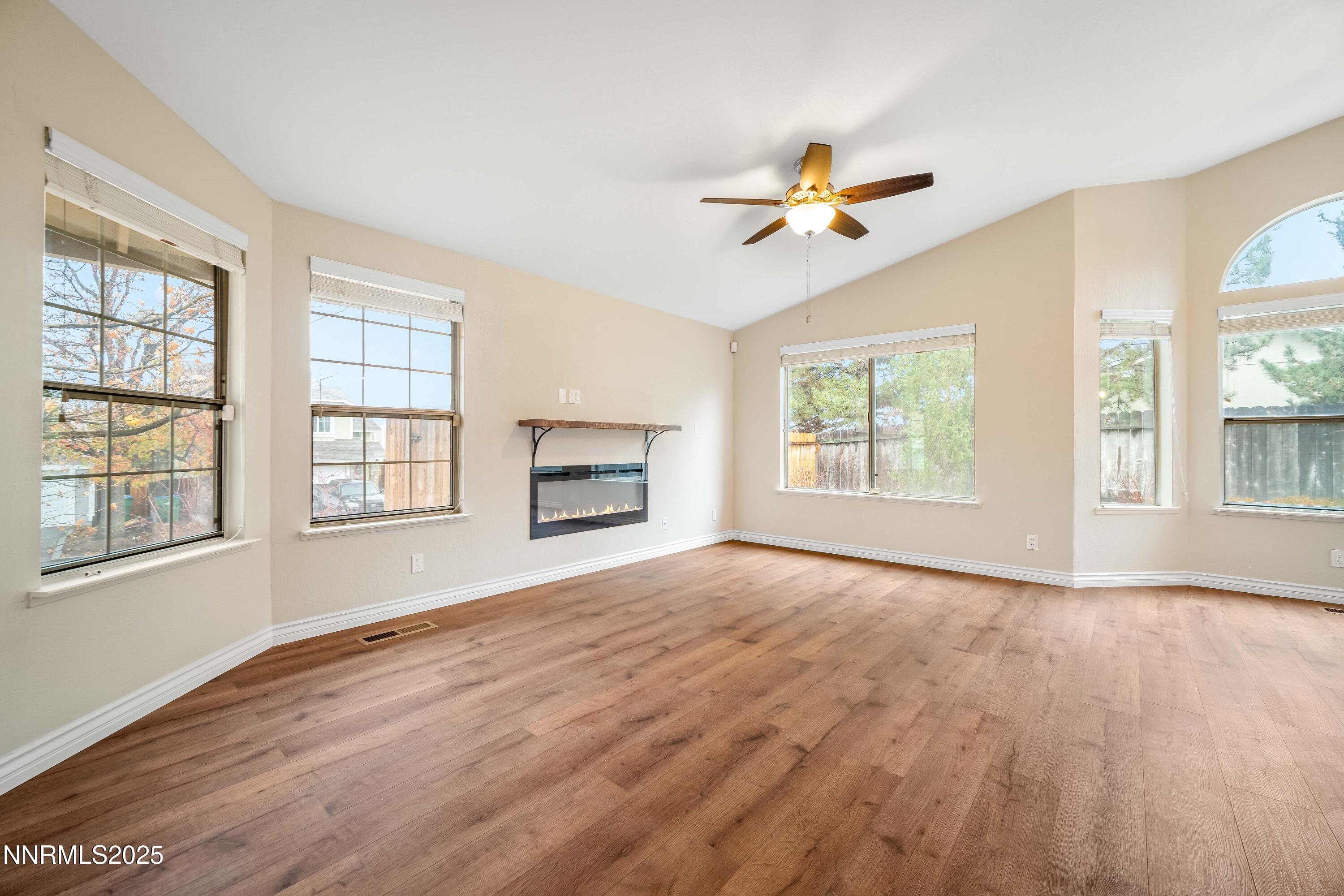 1146 Ambassador Drive Reno, NV 89523 - Photo 2 of 23 a view of empty room with wooden floor and fan