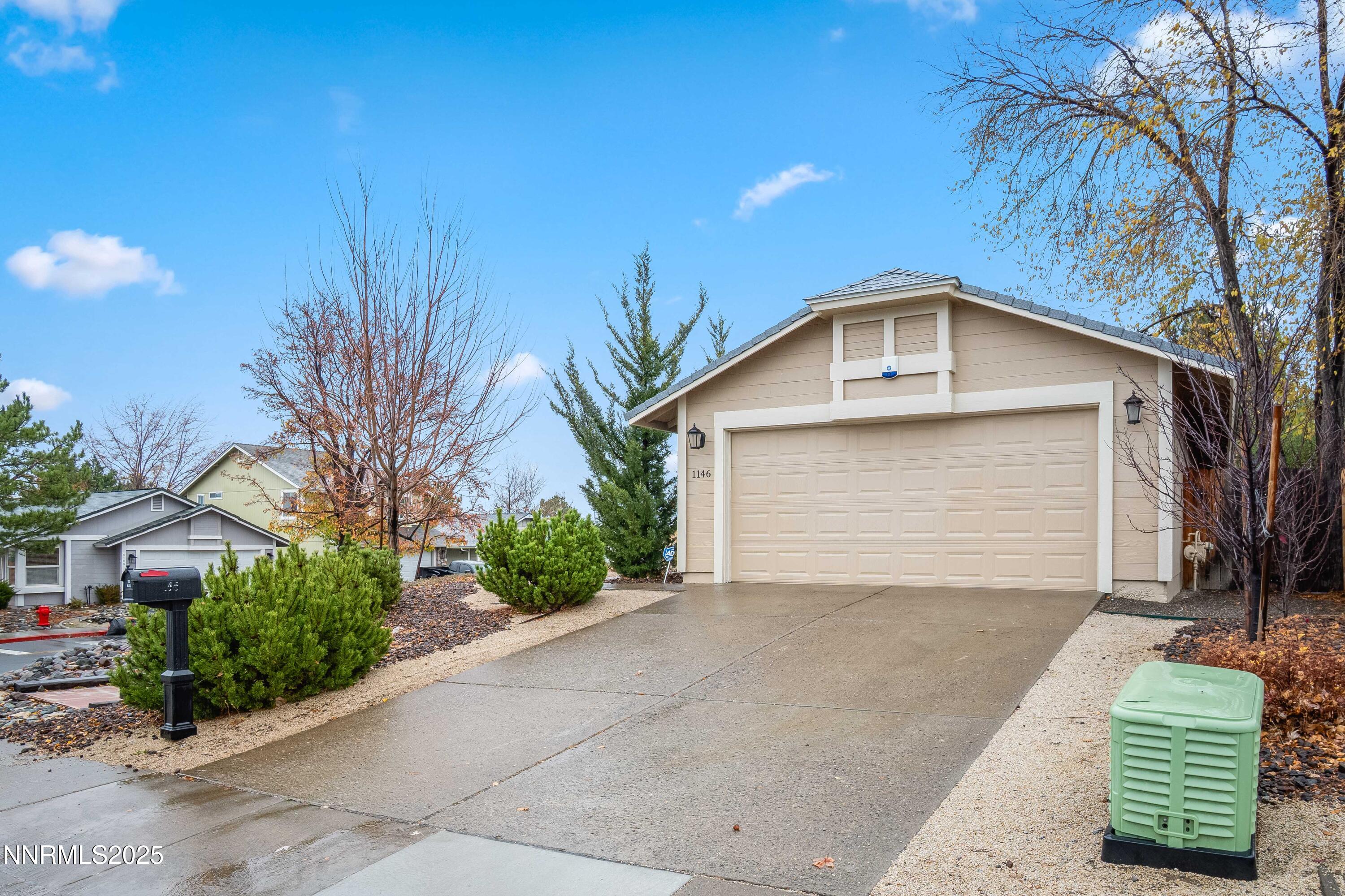 1146 Ambassador Drive Reno, NV 89523 - Photo 22 of 23 a front view of a house with a yard and garage