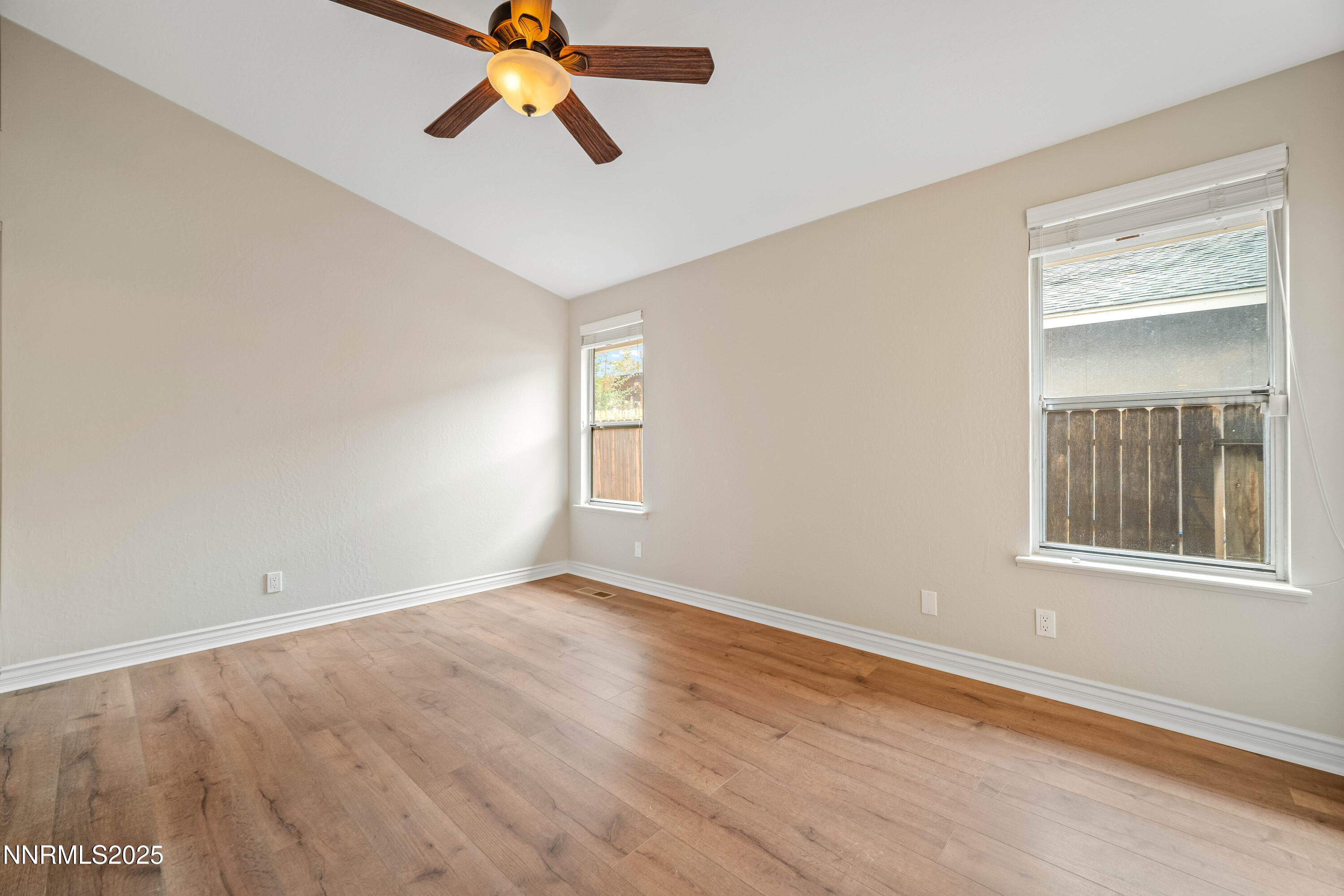 1146 Ambassador Drive Reno, NV 89523 - Photo 9 of 23 a view of empty room with wooden floor and fan