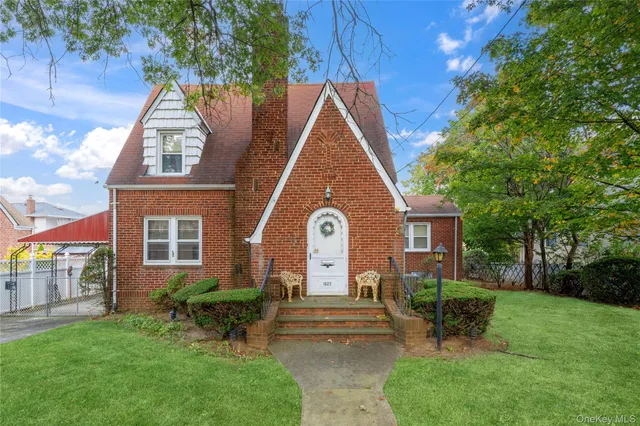 a front view of a house with a garden and plants