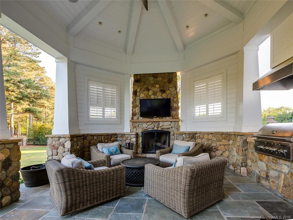 8405 Eagle Glen Charlotte, NC 28210 - Photo 21 of 24 a living room with furniture a flat screen tv and a fireplace