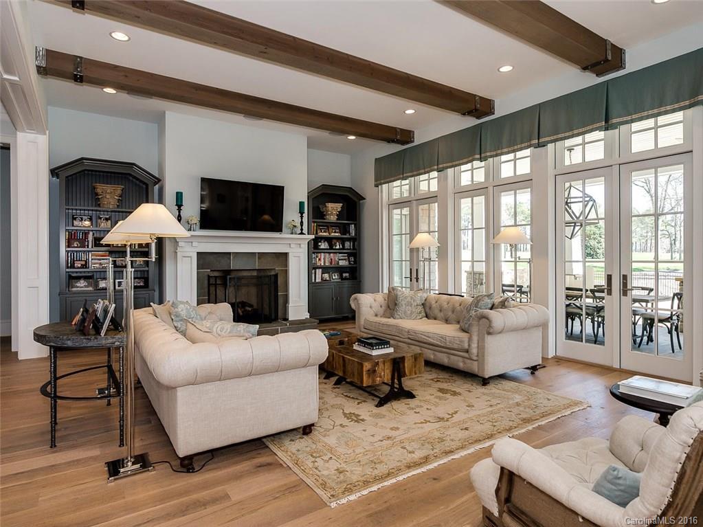 8405 Eagle Glen Charlotte, NC 28210 - Photo 5 of 24 a living room with furniture a flat screen tv and a fireplace