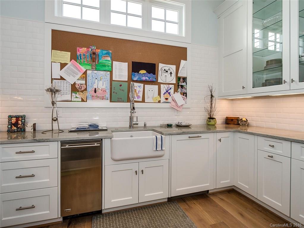 8405 Eagle Glen Charlotte, NC 28210 - Photo 9 of 24 a kitchen with white cabinets and sink